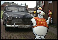 Ice cream sign in front of old Volvo in Stockholm