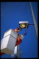 Workers cleaning the mud out of a street light in St. Louis, Missouri.  The Mississippi rose high enough to fill hundreds of street lights with mud.